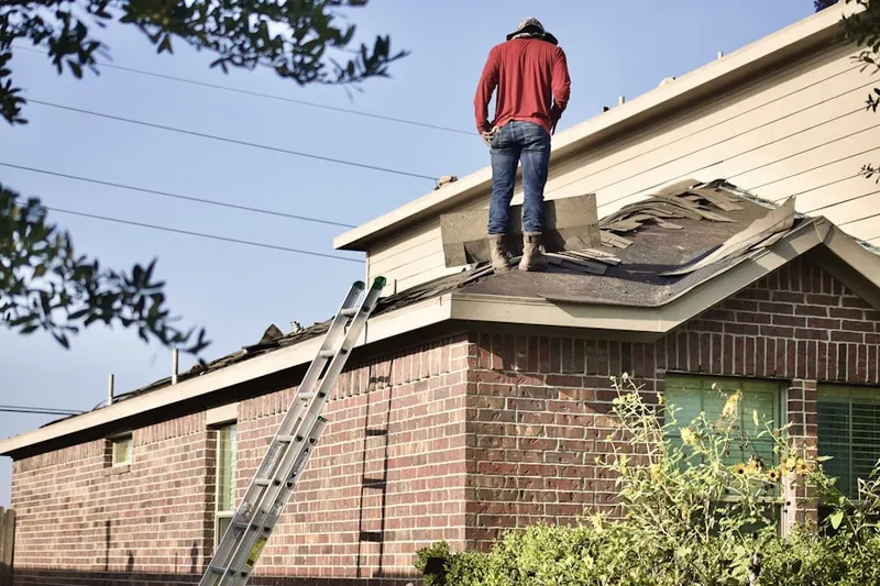 Professional roofer working on a residential roof in Hells Corners